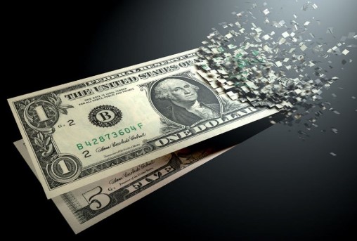 A dollar fading into pixels